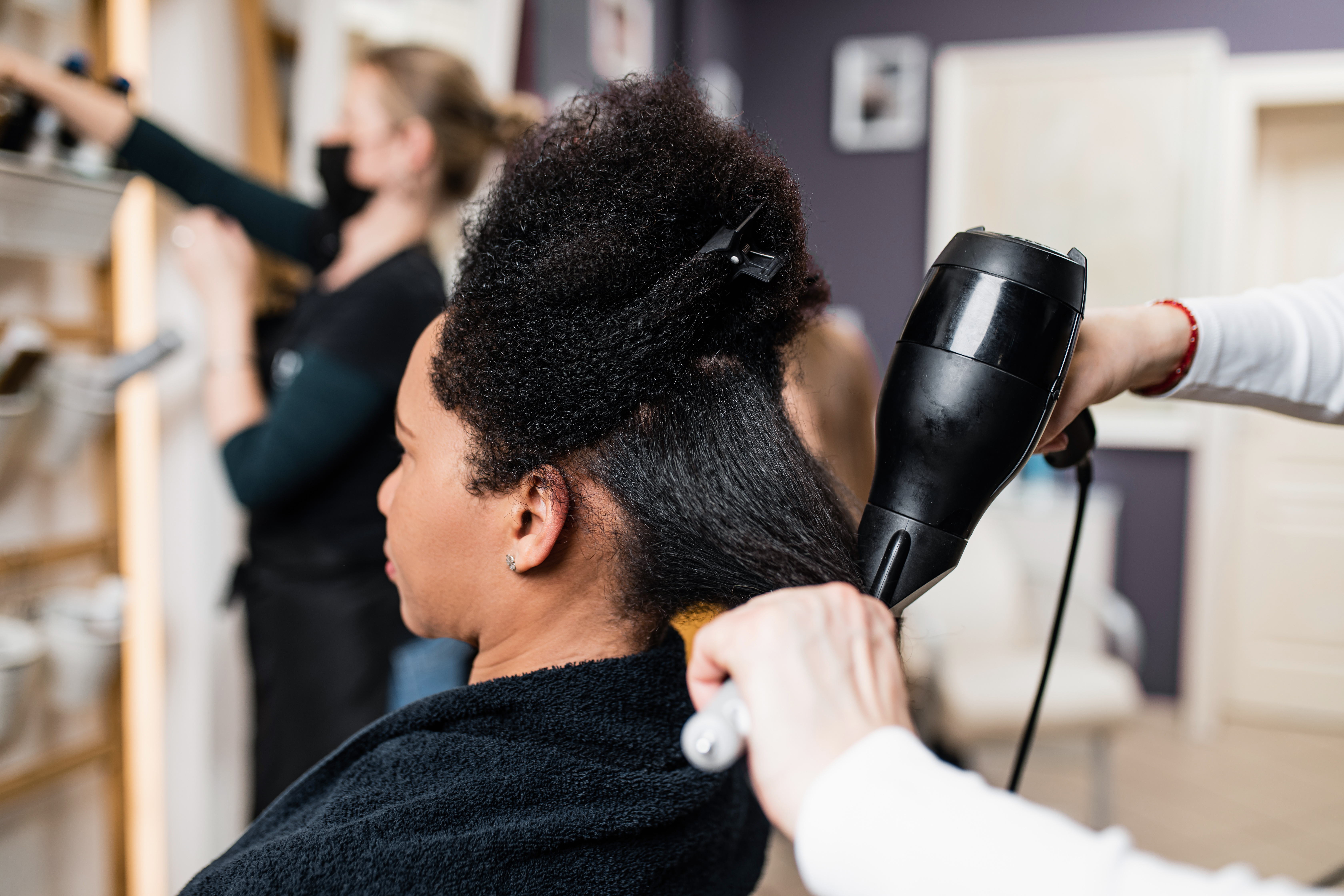 Woman using heat on her hair